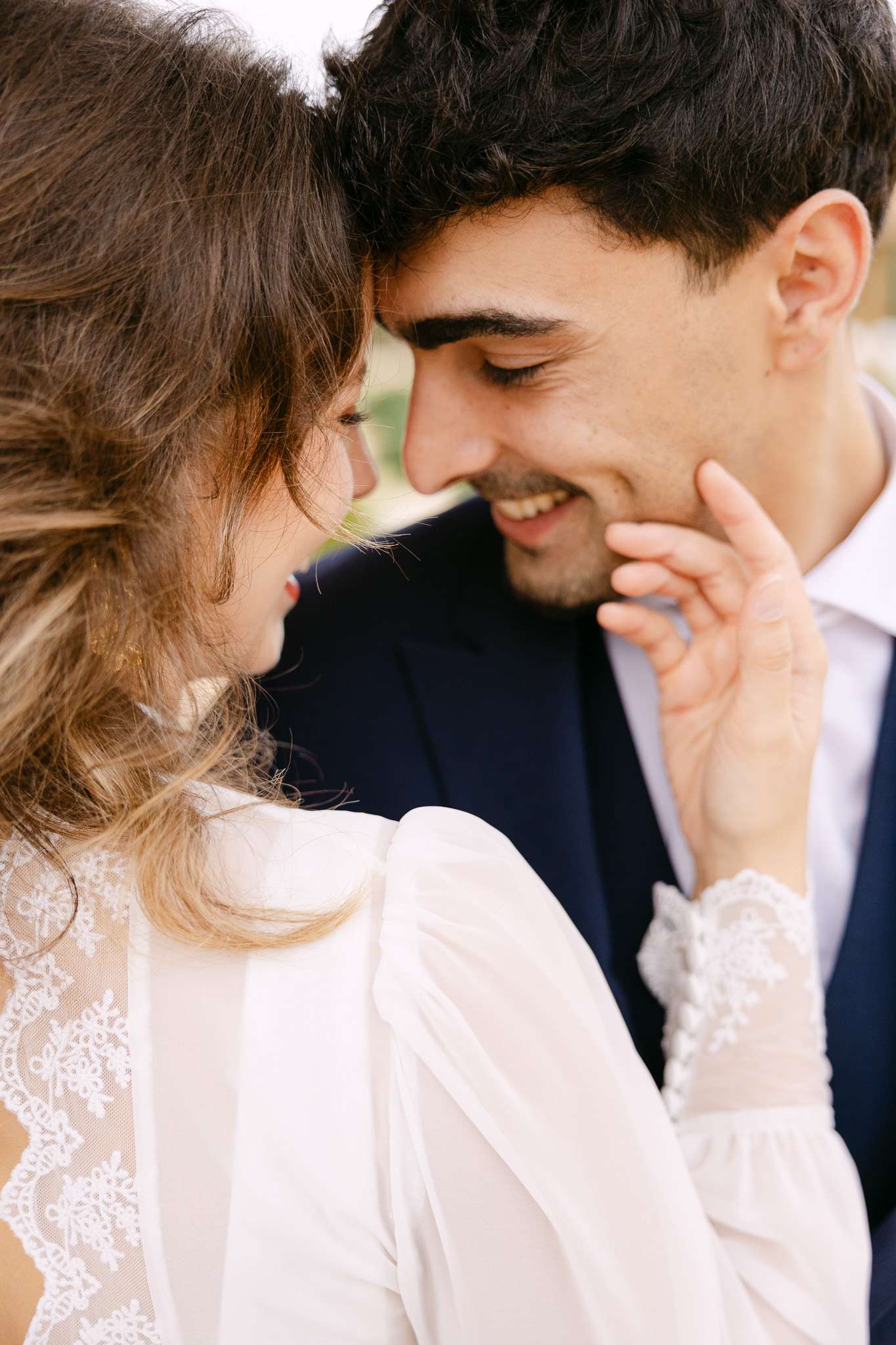 Close-up by a Comporta elopement photographer of bride and groom smiling forehead to forehead.